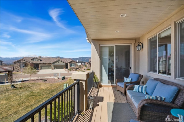balcony featuring a mountain view and an outdoor living space