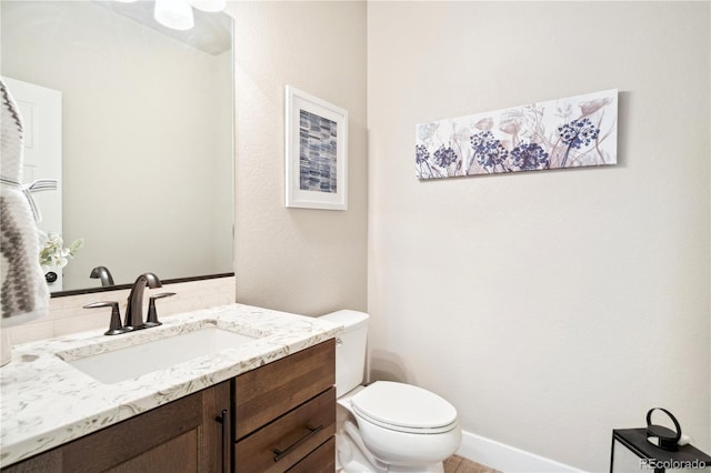 bathroom featuring toilet and vanity