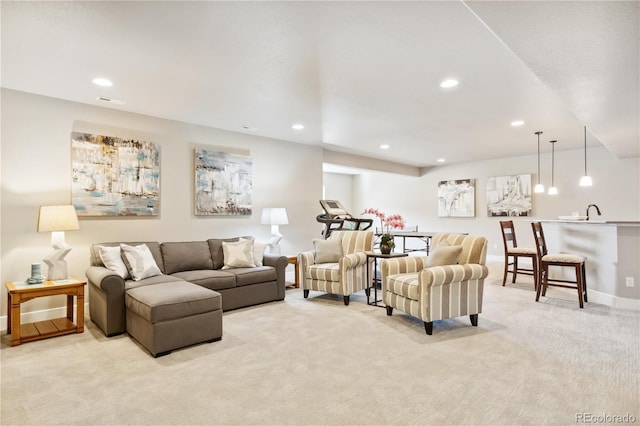 living room with light carpet, recessed lighting, and baseboards