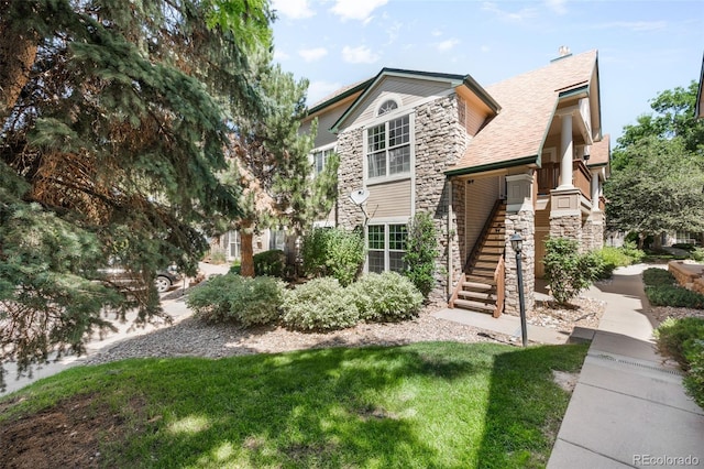 4064 S Carson St Unit 101, Aurora, CO 80014 - view of front of home with stone siding and roof with shingles