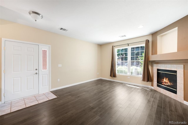 4064 S Carson St Unit 101, Aurora, CO 80014 - unfurnished living room featuring dark wood-style floors and a fireplace