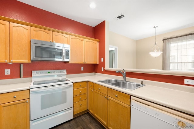 4064 S Carson St Unit 101, Aurora, CO 80014 - kitchen featuring white appliances, light countertops, dark wood-style flooring, and decorative light fixtures