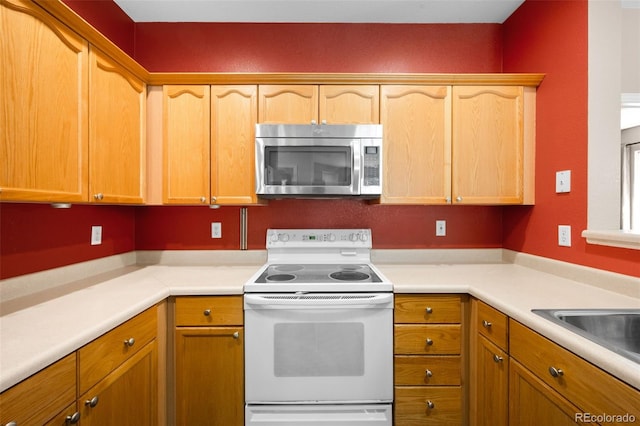 4064 S Carson St Unit 101, Aurora, CO 80014 - kitchen with stainless steel microwave, electric stove, and light countertops