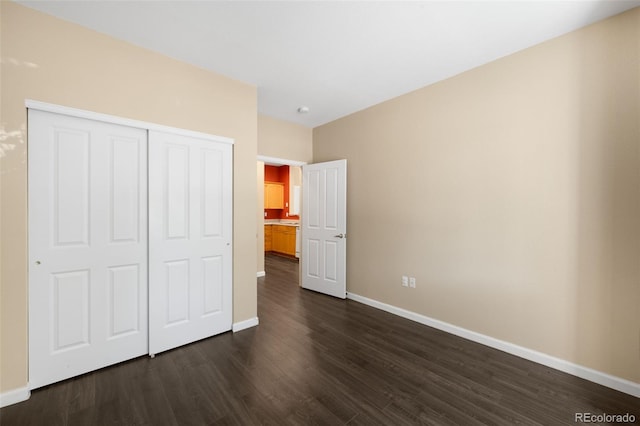 4064 S Carson St Unit 101, Aurora, CO 80014 - unfurnished bedroom featuring dark wood finished floors and a closet