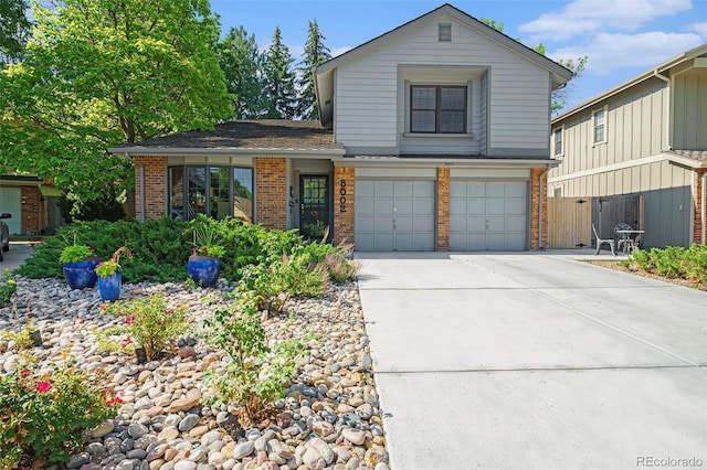 8002 Field Ct, Arvada, CO 80005 - traditional-style house with brick siding, an attached garage, and driveway