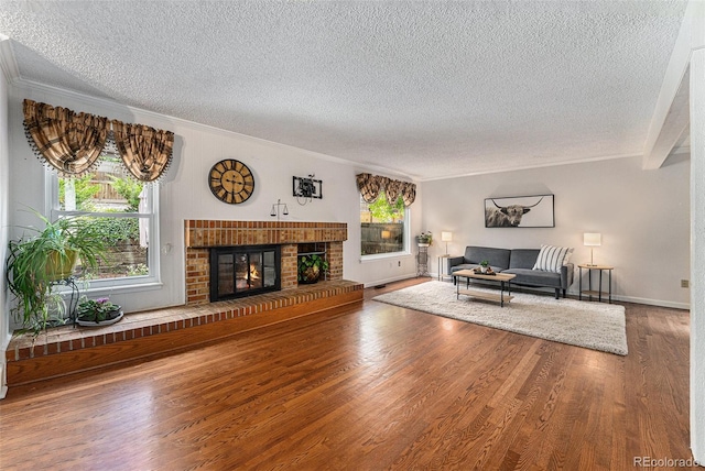 8002 Field Ct, Arvada, CO 80005 - living area with a textured ceiling, crown molding, wood finished floors, and a fireplace