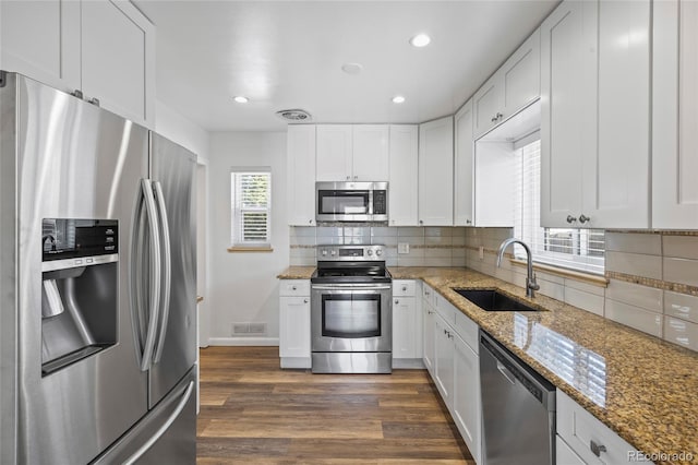 2582 S Uno Way, Denver, CO 80219 - kitchen featuring stainless steel appliances, backsplash, dark wood-style flooring, white cabinets, and recessed lighting