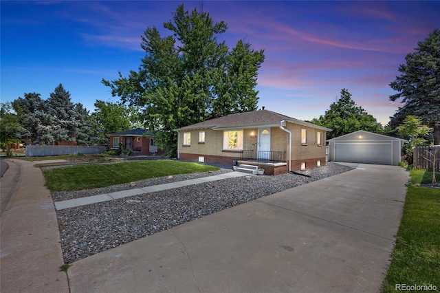 2582 S Uno Way, Denver, CO 80219 - view of front facade with a detached garage, brick siding, and an outdoor structure
