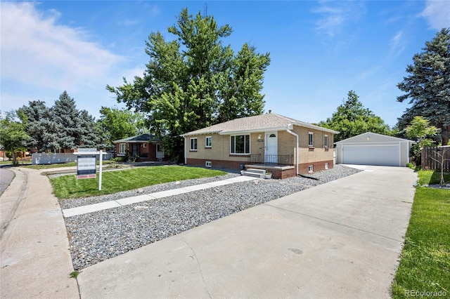2582 S Uno Way, Denver, CO 80219 - view of front facade featuring a garage, brick siding, a front lawn, and an outdoor structure
