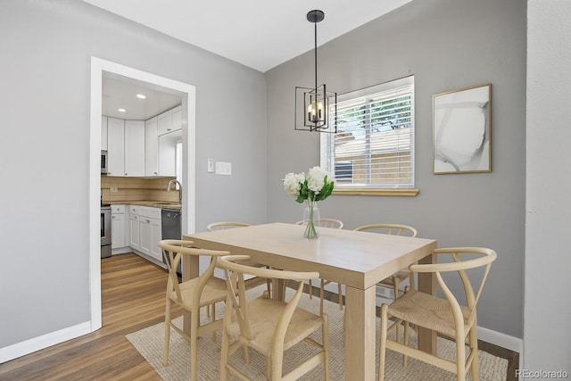 2582 S Uno Way, Denver, CO 80219 - dining space featuring wood finished floors and a chandelier