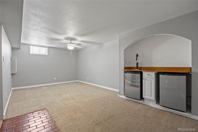 2582 S Uno Way, Denver, CO 80219 - unfurnished living room with bar with sink, light colored carpet, a textured ceiling, and ceiling fan