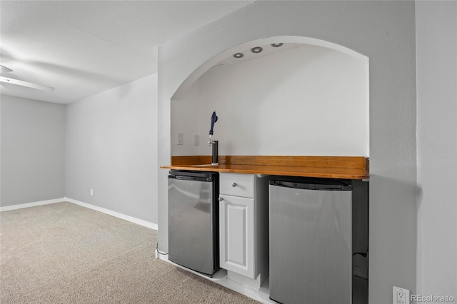 2582 S Uno Way, Denver, CO 80219 - indoor bar with fridge, light carpet, and arched walkways