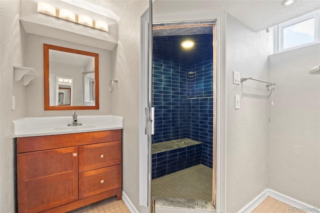 2582 S Uno Way, Denver, CO 80219 - bathroom featuring a stall shower, vanity, and tile patterned floors