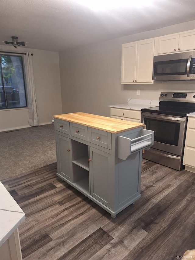 6207 W 92nd Pl, Westminster, CO 80031 - kitchen featuring stainless steel appliances, butcher block counters, gray cabinets, white cabinets, and dark wood finished floors