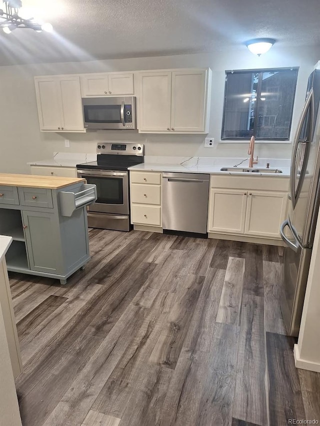 6207 W 92nd Pl, Westminster, CO 80031 - kitchen with stainless steel appliances, dark wood-style flooring, and a textured ceiling