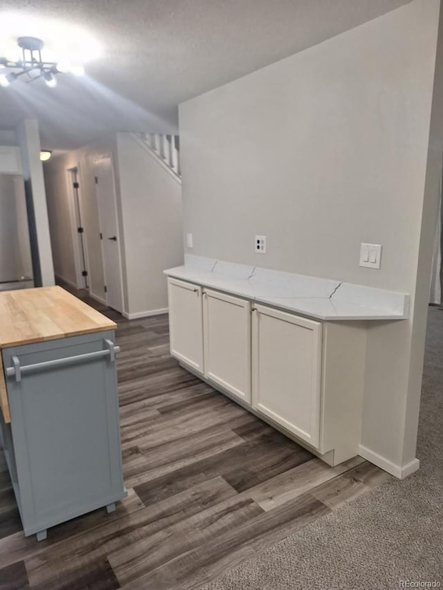 6207 W 92nd Pl, Westminster, CO 80031 - kitchen featuring butcher block counters, dark wood-type flooring, white cabinetry, and refrigerator