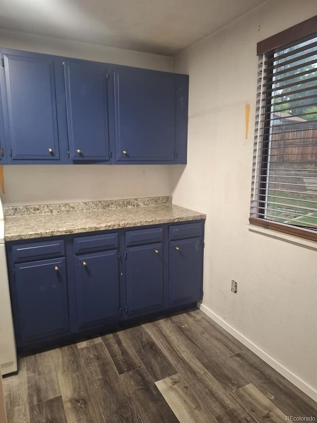 6207 W 92nd Pl, Westminster, CO 80031 - kitchen with blue cabinetry, dark wood-type flooring, and light countertops