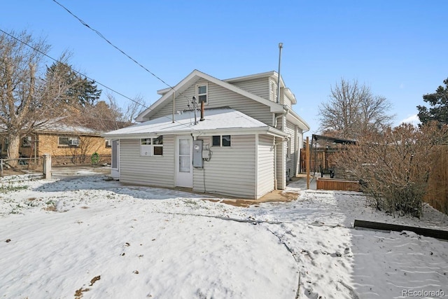 view of snow covered rear of property