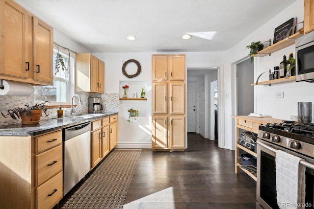 kitchen featuring open shelves, appliances with stainless steel finishes, a sink, light brown cabinets, and decorative backsplash