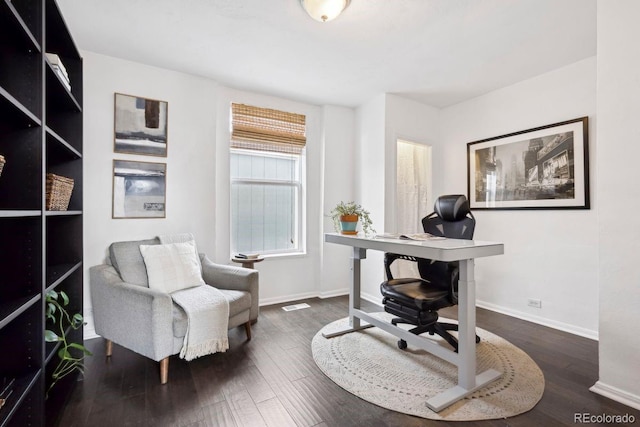 home office featuring baseboards, visible vents, and wood finished floors