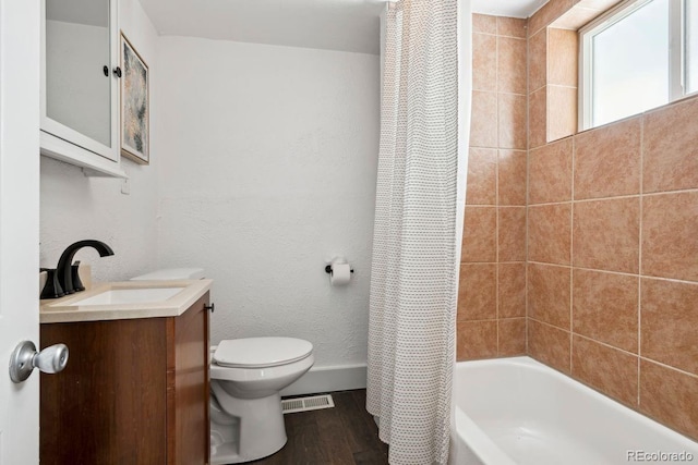 bathroom featuring visible vents, vanity, wood finished floors, toilet, and baseboards
