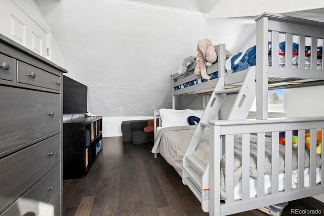 bedroom with dark wood-style flooring