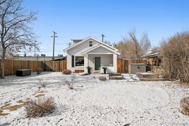 view of front of house with a jacuzzi and a fenced backyard