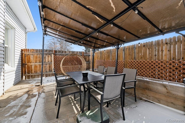 view of patio with fence and outdoor dining area