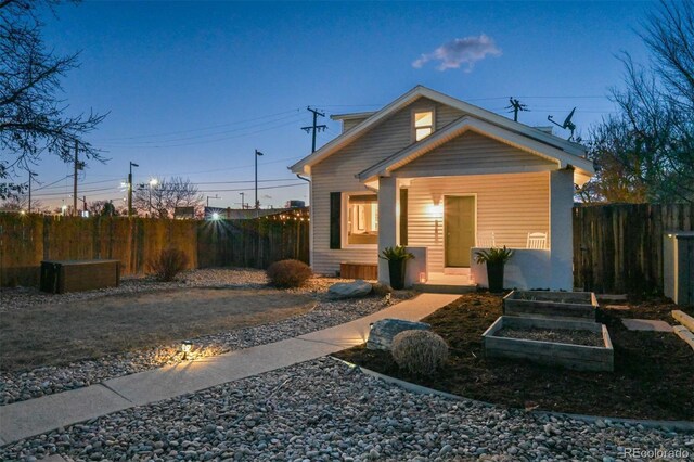 1535 Spruce St, Denver, CO 80220 - view of front of home with a garden and fence