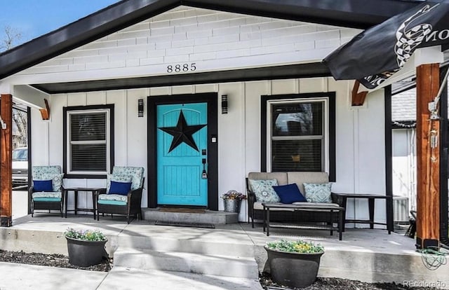 8885 W 64th Pl, Arvada, CO 80004 - doorway to property with a porch and board and batten siding