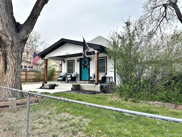 8885 W 64th Pl, Arvada, CO 80004 - bungalow with covered porch, fence private yard, and a front lawn