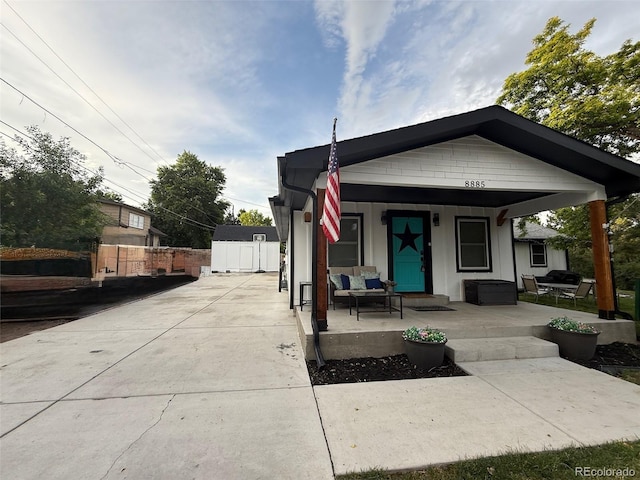 8885 W 64th Pl, Arvada, CO 80004 - view of front facade with covered porch and board and batten siding
