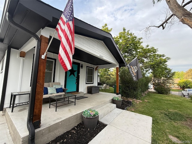 8885 W 64th Pl, Arvada, CO 80004 - porch with a lawn and an outdoor living space