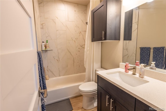 full bathroom with vanity, hardwood / wood-style floors, shower / bath combo with shower curtain, and toilet