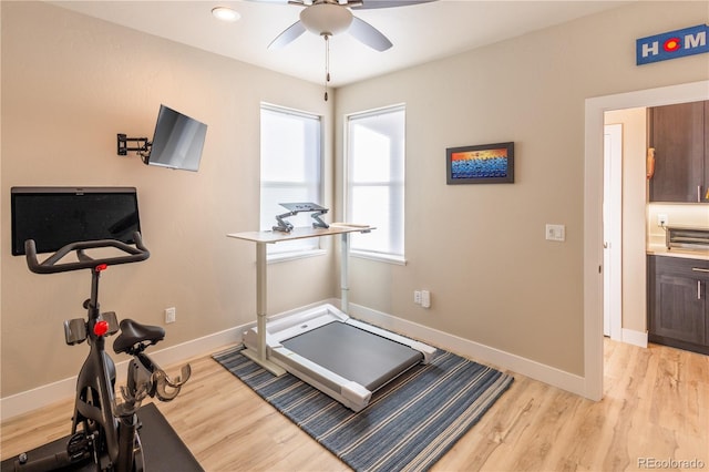 workout area with ceiling fan and light hardwood / wood-style floors