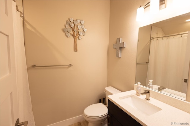 bathroom featuring toilet and vanity