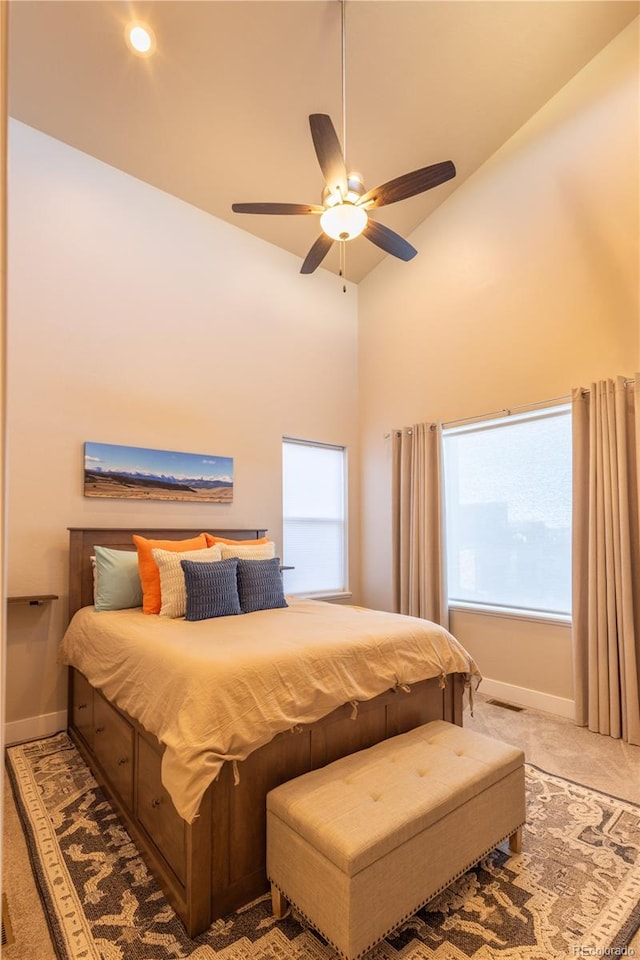 bedroom with high vaulted ceiling, ceiling fan, and carpet flooring