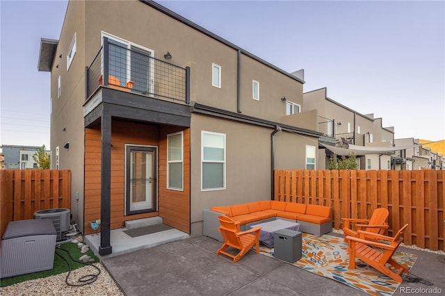 back of property featuring a patio area, central AC unit, and outdoor lounge area