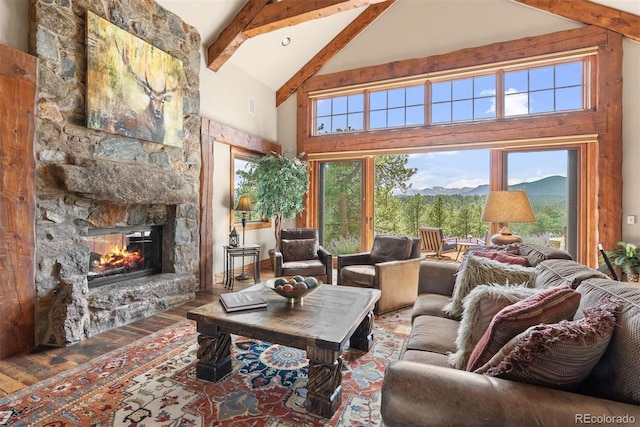 2929 Highlands View Rd, Evergreen, CO 80439 - living area featuring beamed ceiling, high vaulted ceiling, a fireplace, wood finished floors, and a mountain view