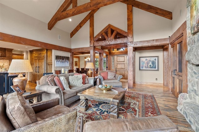 2929 Highlands View Rd, Evergreen, CO 80439 - living area featuring high vaulted ceiling, beam ceiling, and wood finished floors