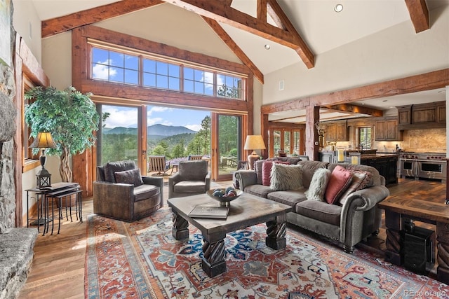 2929 Highlands View Rd, Evergreen, CO 80439 - living area with high vaulted ceiling, beam ceiling, a mountain view, and light wood finished floors