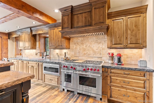 2929 Highlands View Rd, Evergreen, CO 80439 - kitchen with stainless steel appliances, light wood-style floors, decorative backsplash, recessed lighting, and beamed ceiling