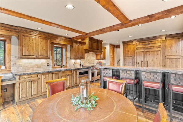 2929 Highlands View Rd, Evergreen, CO 80439 - kitchen featuring double oven range, recessed lighting, beam ceiling, light wood-type flooring, and decorative backsplash