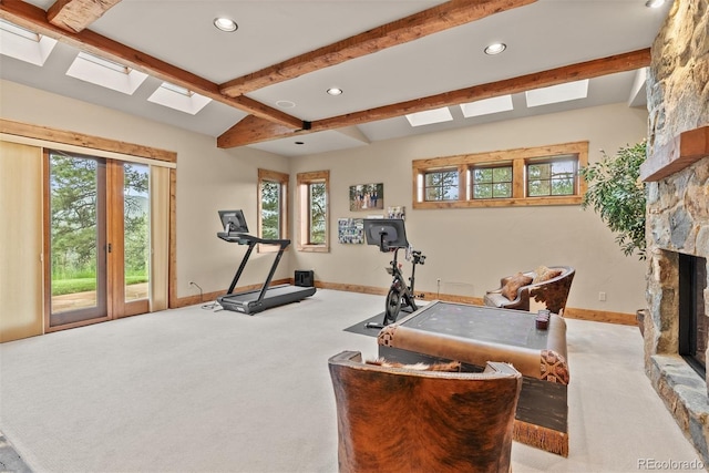 2929 Highlands View Rd, Evergreen, CO 80439 - exercise room with a skylight, carpet floors, a stone fireplace, and recessed lighting
