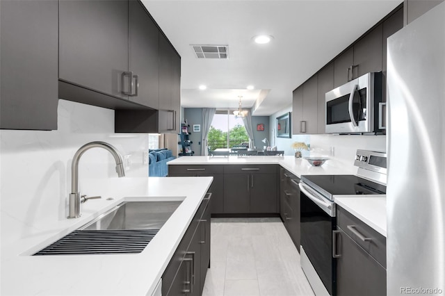 5955 E 10th Ave Unit 507, Denver, CO 80220 - kitchen with appliances with stainless steel finishes, a peninsula, light countertops, modern cabinets, and recessed lighting