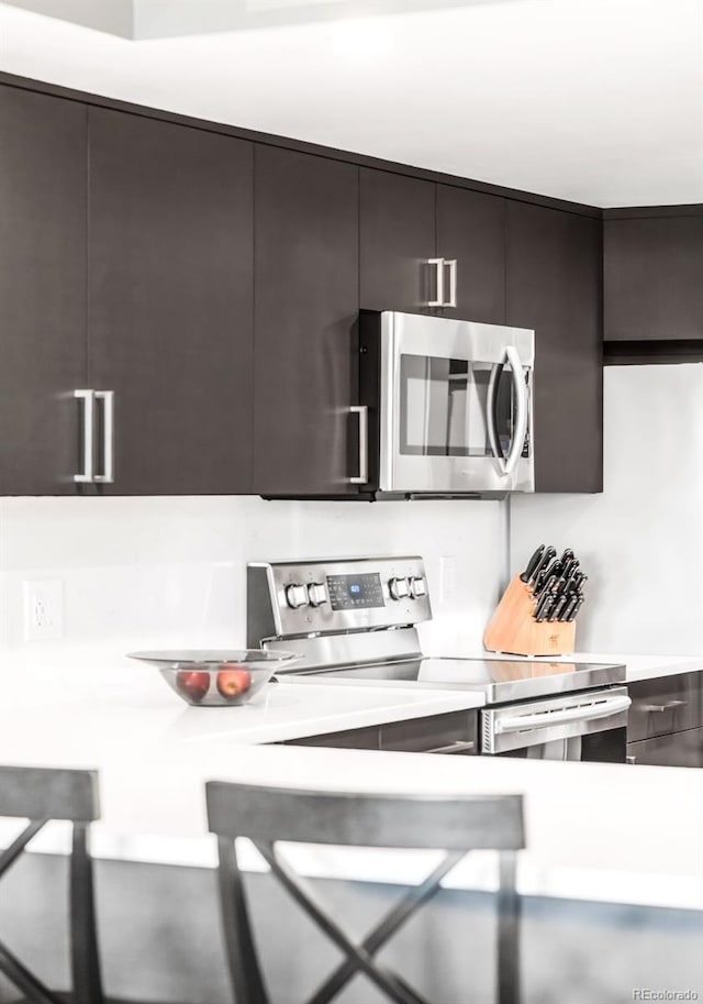 5955 E 10th Ave Unit 507, Denver, CO 80220 - kitchen featuring stainless steel appliances, light countertops, and modern cabinets