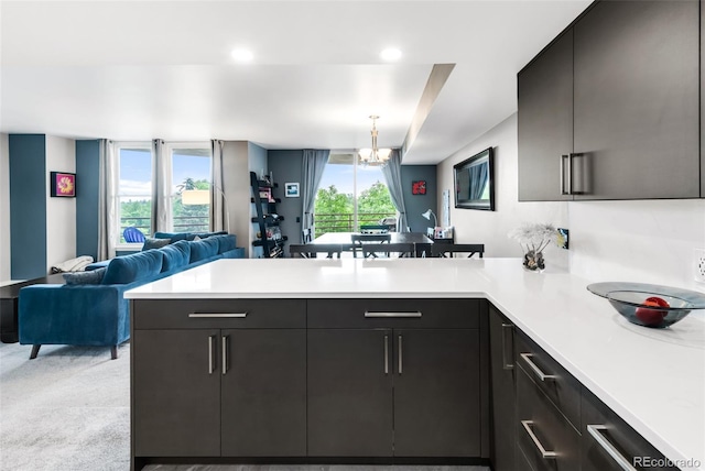 5955 E 10th Ave Unit 507, Denver, CO 80220 - kitchen with a peninsula, open floor plan, light countertops, a chandelier, and recessed lighting