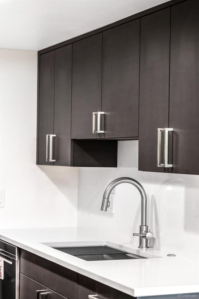 5955 E 10th Ave Unit 507, Denver, CO 80220 - kitchen with modern cabinets, light countertops, backsplash, and dark brown cabinetry
