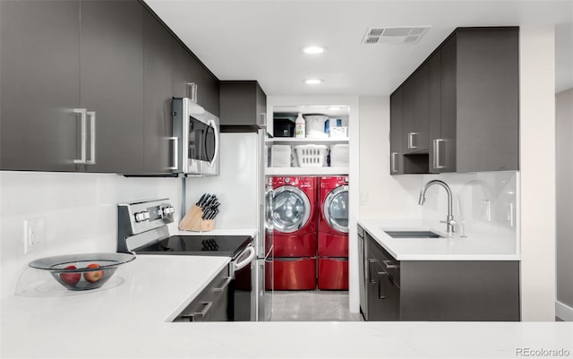 5955 E 10th Ave Unit 507, Denver, CO 80220 - kitchen with washing machine and clothes dryer, appliances with stainless steel finishes, light countertops, recessed lighting, and modern cabinets