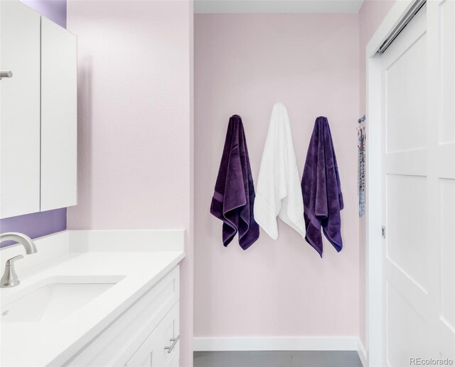 5955 E 10th Ave Unit 507, Denver, CO 80220 - bathroom with vanity and baseboards